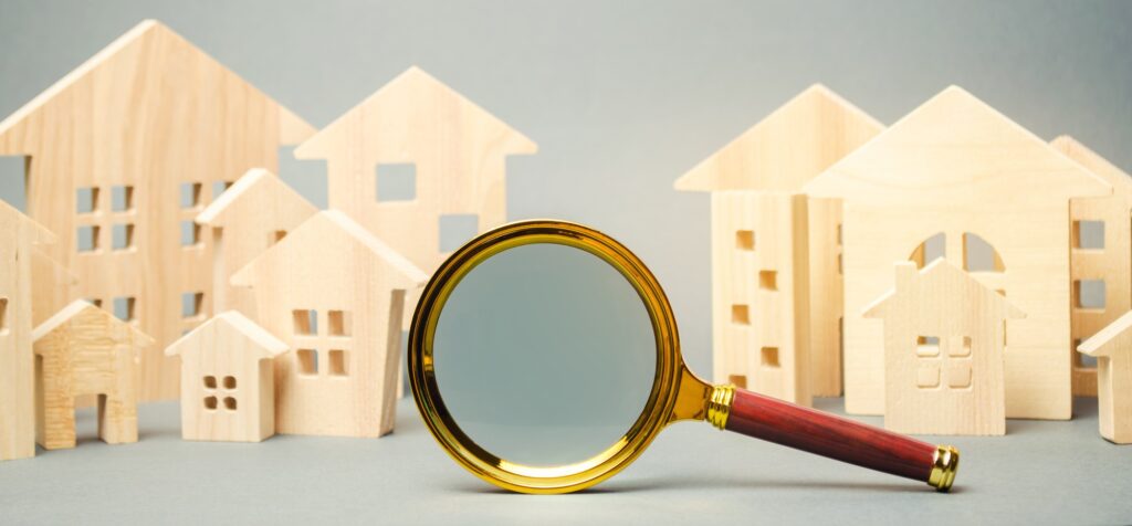 Magnifying glass and wooden houses